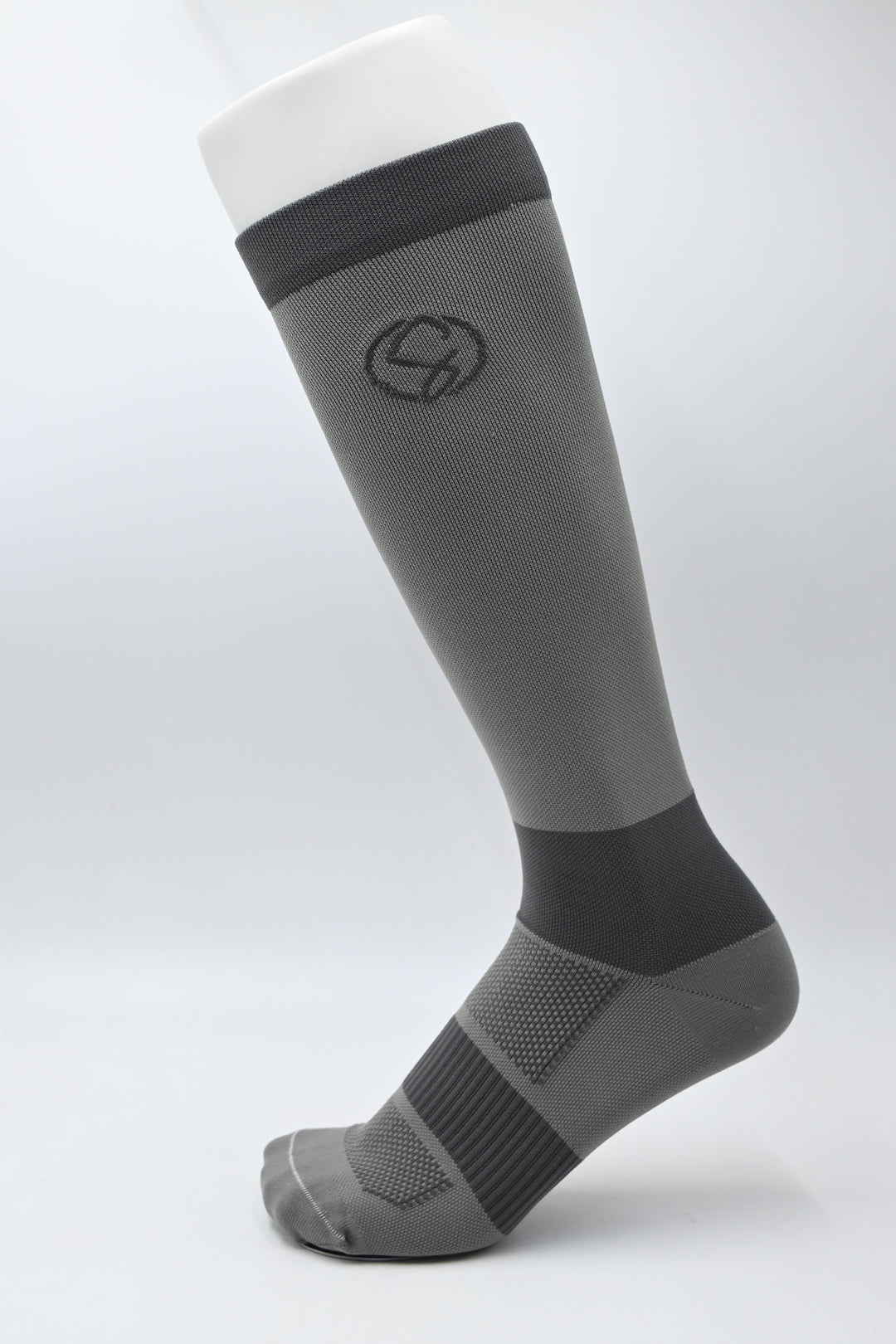 Gray and black knee-high sock on a light gray background