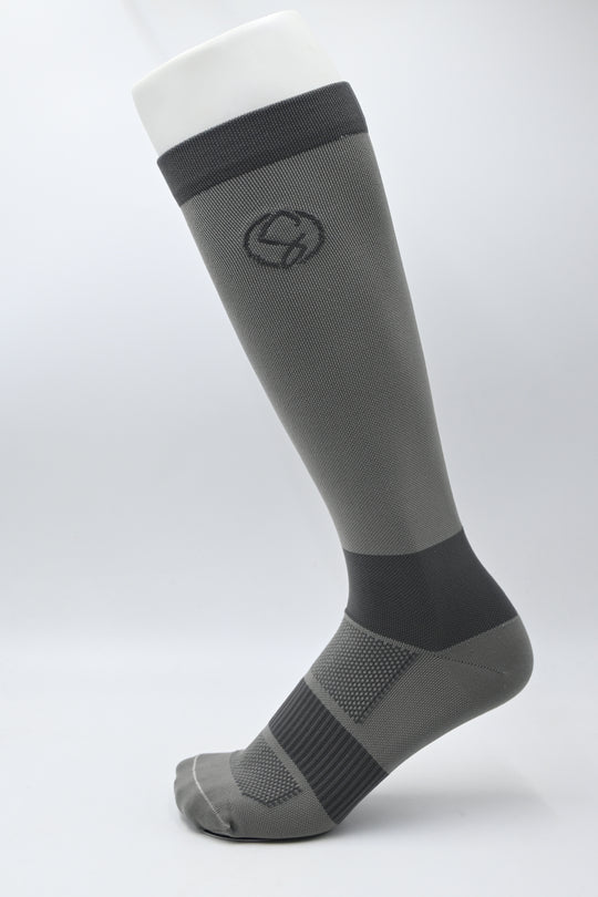 Gray and black knee-high sock on a light gray background