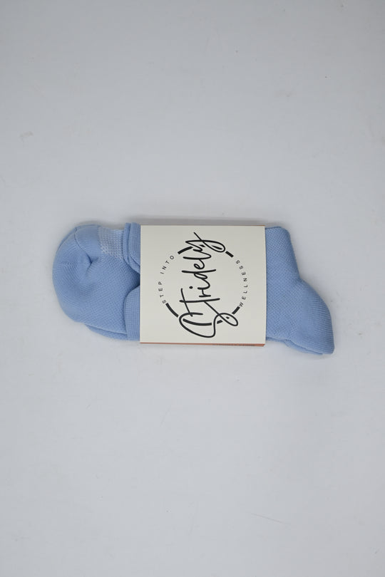 Blue sock with a white label on a light gray background